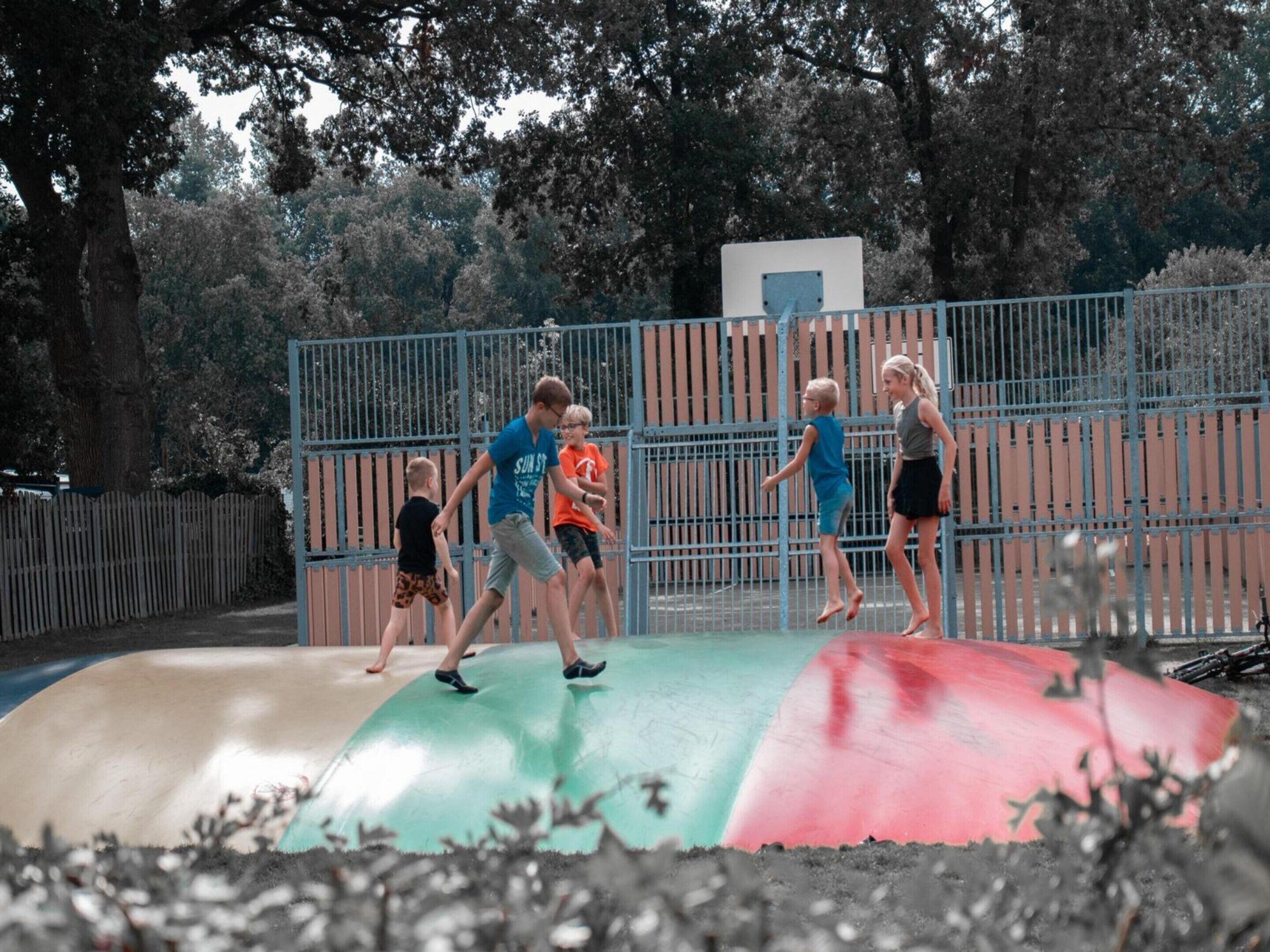 A playground with a slide and a fenced area.