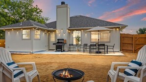 A house with a backyard patio, outdoor seating, a fire pit, and a barbecue grill. - Texas Getaway w/ Fire Pit, Grill & Ping-Pong (Leander)