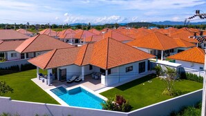 Un quartiere residenziale con diverse case caratterizzate da tetti in tegole rosse e architettura moderna.