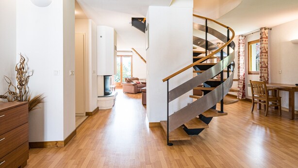 A modern interior with a spiral staircase, wooden flooring, and a dining area. - Birdie F Ndeg21 - 5p10 (Giez)
