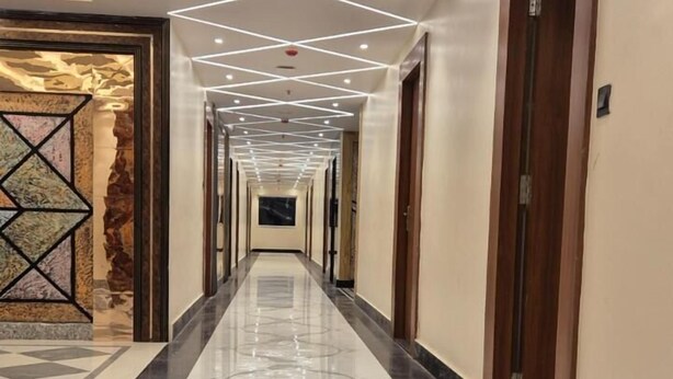 A long, polished hallway with a geometric ceiling design and marble flooring. - HOTEL SEA SOUL AYAN GROUP OF HOTEL  (Digha)