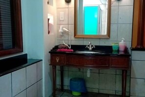 A bathroom with a sink, mirror, and a window. - Premium Water Chalet 2 (Port Dickson)