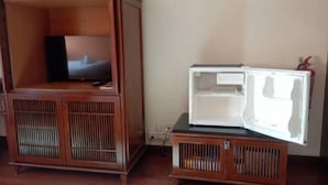 A wooden cabinet with a television and a white refrigerator. - Premium Water Chalet 2 (Port Dickson)