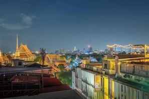 A cityscape at night with illuminated buildings and a prominent temple structure. - Ralph Bangkok (Bangkok)