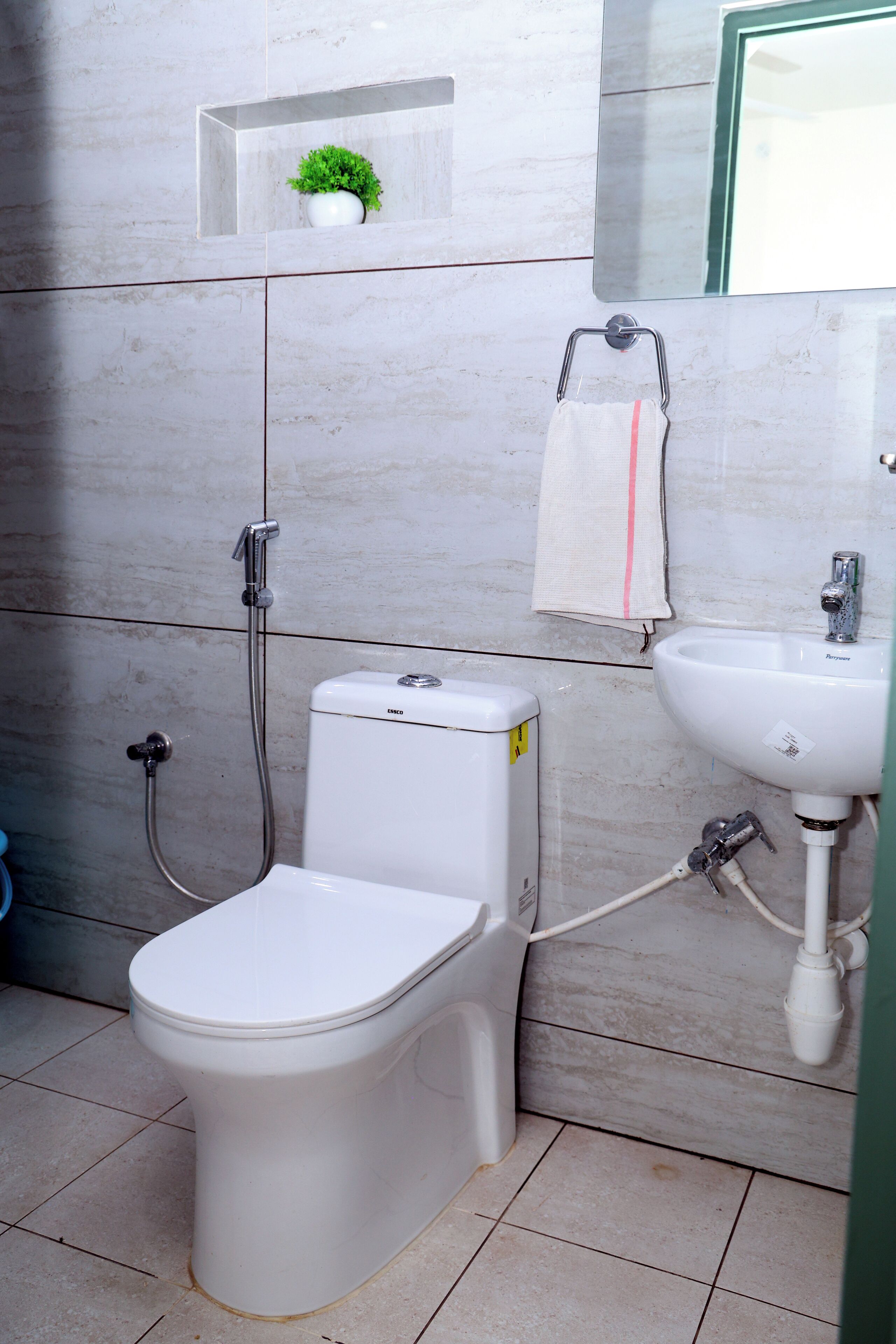 Une salle de bain avec des toilettes, un lavabo et une douche.