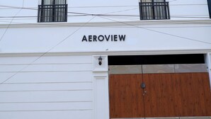 A white multi-story building with the name "AEROVIEW" on the facade. - Aeroview Homestay Chennai Airport (Chennai)