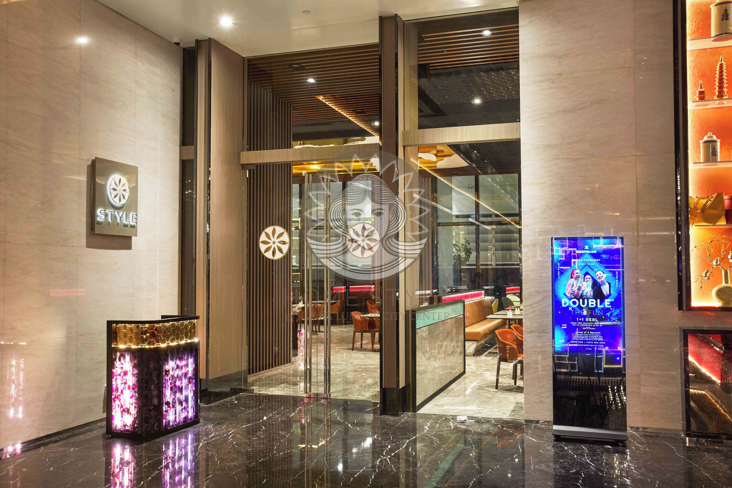 A modern hotel lobby with a marble floor, a reception desk, and a 'STYLE' sign.
