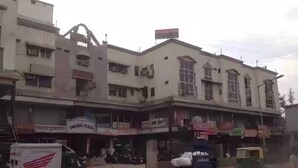 A multi-story building with various shops on the ground floor. - Rajshree Hotel (Ahmedabad)