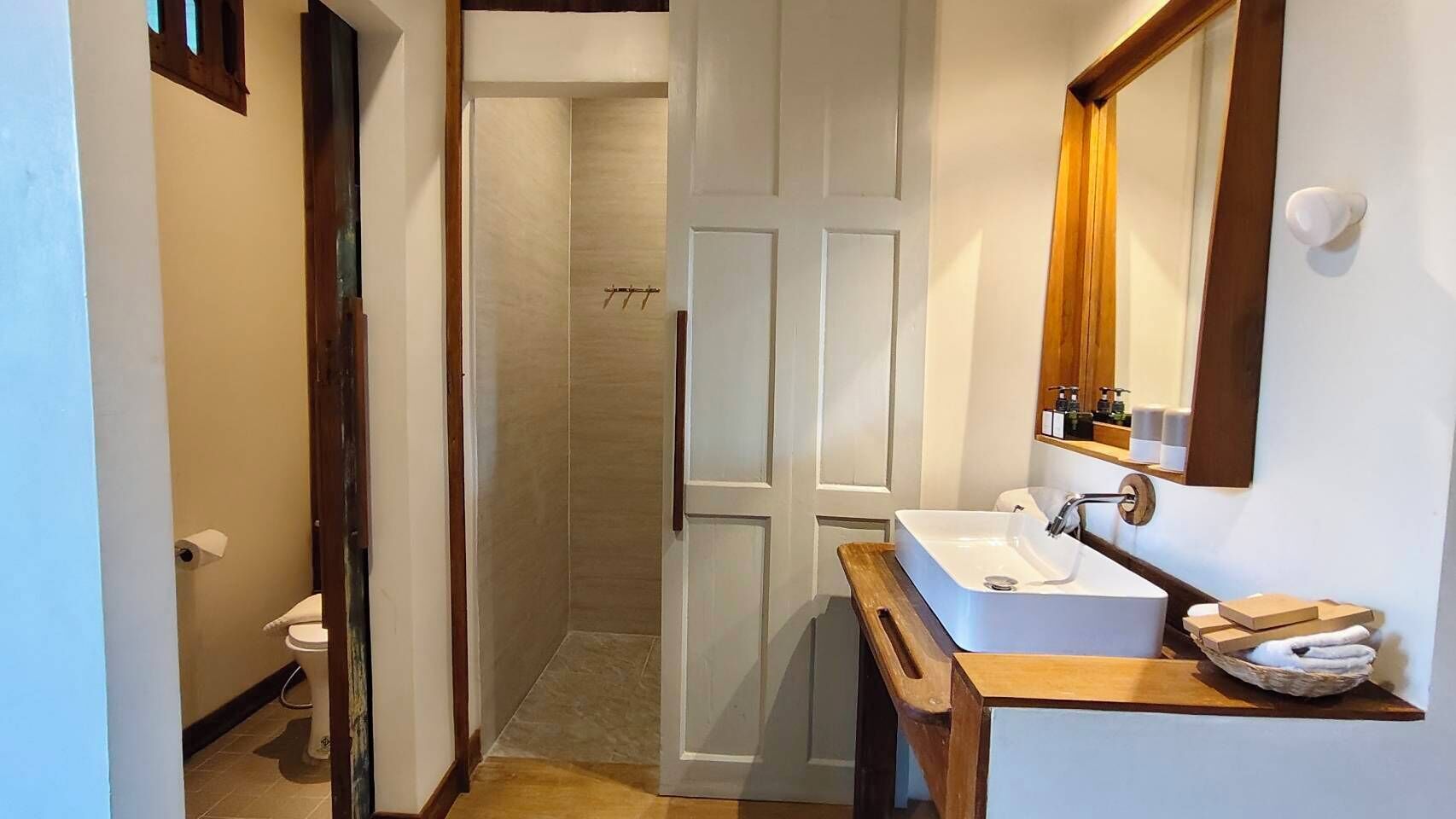 A bathroom with a shower, toilet, and sink.