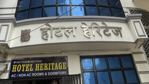 A building with a sign reading "HOTEL HERITAGE" and another sign in a different language. - Hotel Heritage (Varanasi)