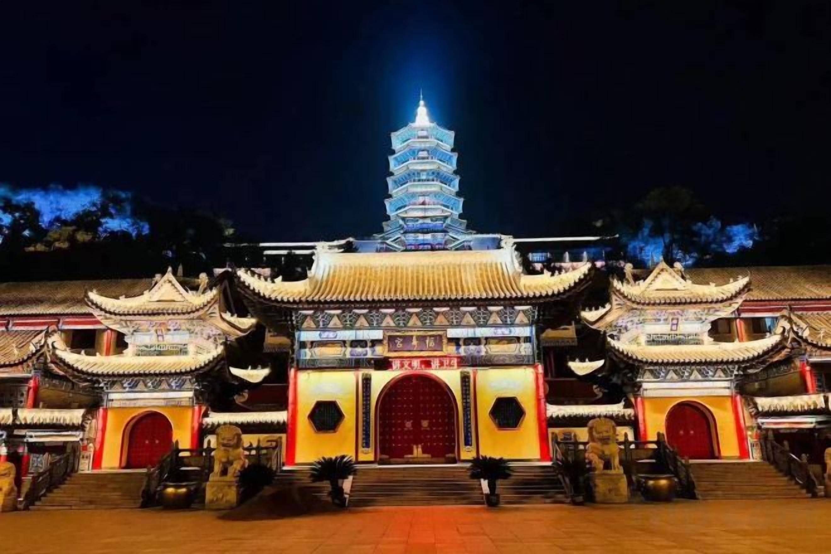 A traditional multi-tiered pagoda-style building with a central staircase leading to the entrance.