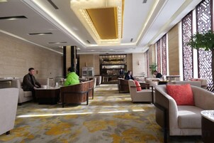 A spacious lobby with seating areas and a reception desk.