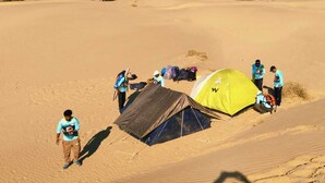 A group of people setting up tents in a desert environment. - Desert View Resort (Jaisalmer)