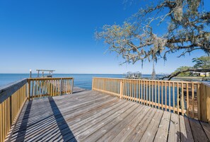 A wooden pier extending into a calm sea, with a clear sky above. - Bay Leave (Gulf Shores)