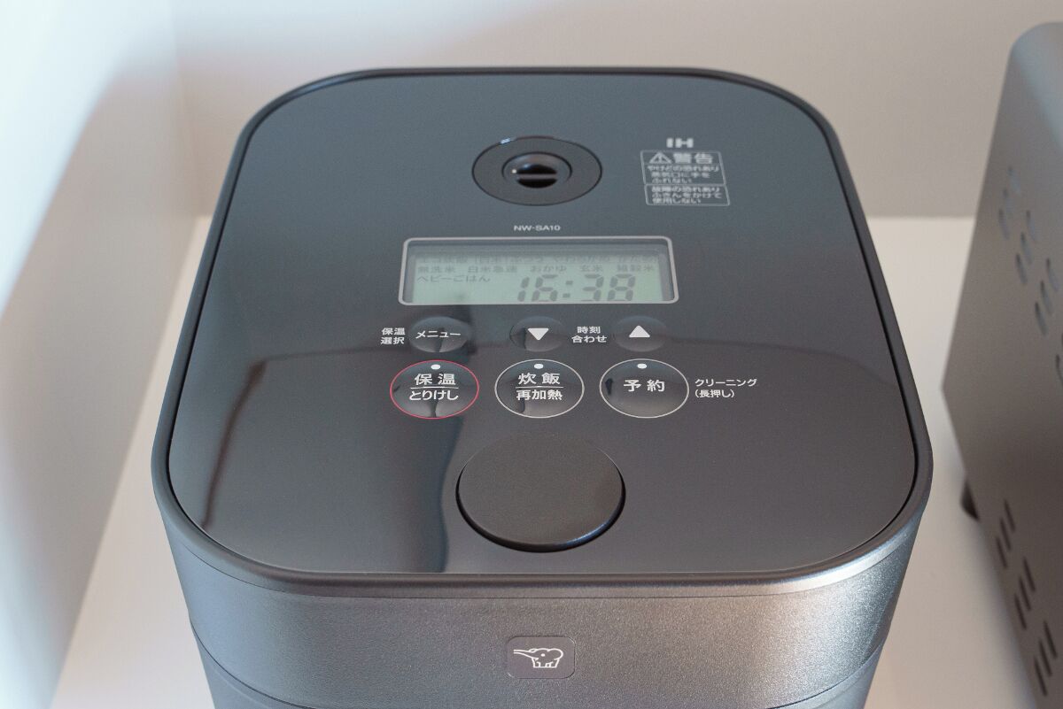 A compact, modern device with a digital display, buttons, and a ventilation hole.