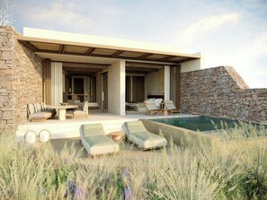 A modern outdoor living area with a pool, stone walls, and lounge chairs. - The Revery, Elafonisi - Member of Leading Hotels of the World (Kissamos)