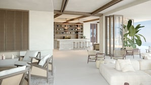 A modern living area with a bar, seating, and a large plant. - The Revery, Elafonisi - Member of Leading Hotels of the World (Kissamos)