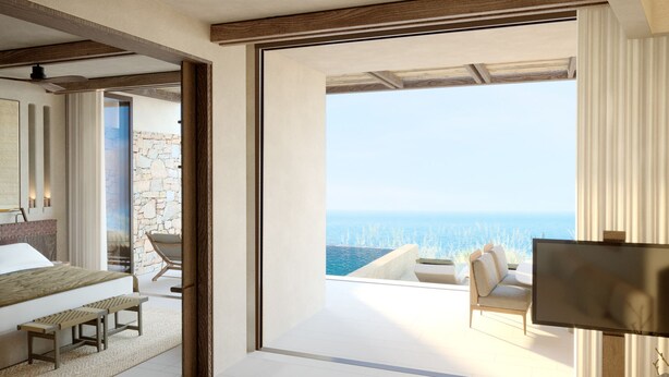 A modern hotel room with a large balcony, a bed, a seating area, and a TV. - The Revery, Elafonisi - Member of Leading Hotels of the World (Kissamos)
