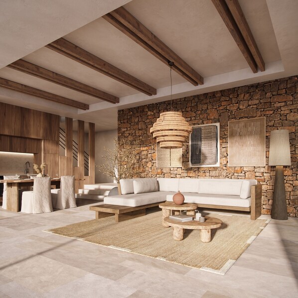 A modern living room with a stone wall, wooden beams, a sofa, a coffee table, and a dining area with chairs and a table. - The Revery, Elafonisi - Member of Leading Hotels of the World (Kissamos)