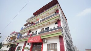 A multi-story building with the name 'NOVA' prominently displayed on the facade. - NOVA RESORTS (Raebareli)
