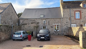 A stone building with two cars parked in front. - 3 km from the sea, typical Normandy house (Anneville-en-Saire)