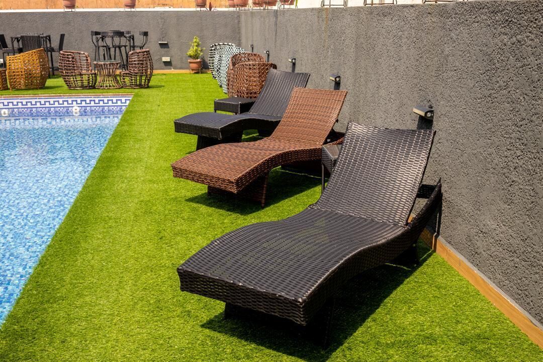 A poolside area with lounge chairs and a small table.