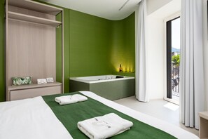 A modern hotel room with a bed, a green wall, a bathtub, and a view of the outside. - Blue Sky Luxury Palace | Apartment with Private Jacuzzi near the Beach (Meta)
