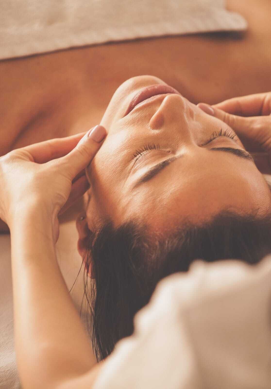 A person lying down with hands on their head, suggesting a relaxed or resting position.