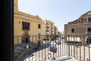 A street view with buildings, a pedestrian crossing, and a parked van.