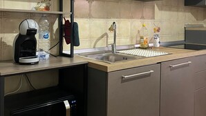 A modern kitchen with a microwave, coffee maker, and a sink. - Alta Marea Portoscuso (SU) - 6 Beds, Seafront and Pinewood! (Portoscuso)
