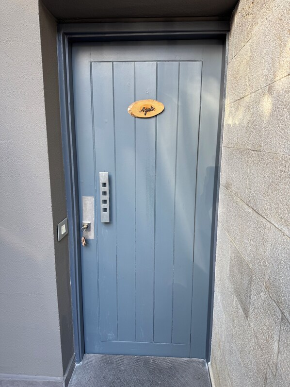 A blue door with a wooden plaque reading "Agate," a keypad, and a doorbell. - The Cozy Inn - Agate (Faqra - Kfardebiane,)