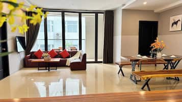 Deluxe Apartment, 2 Bedrooms, City View | Living area | 55-inch LED TV with cable channels, streaming services