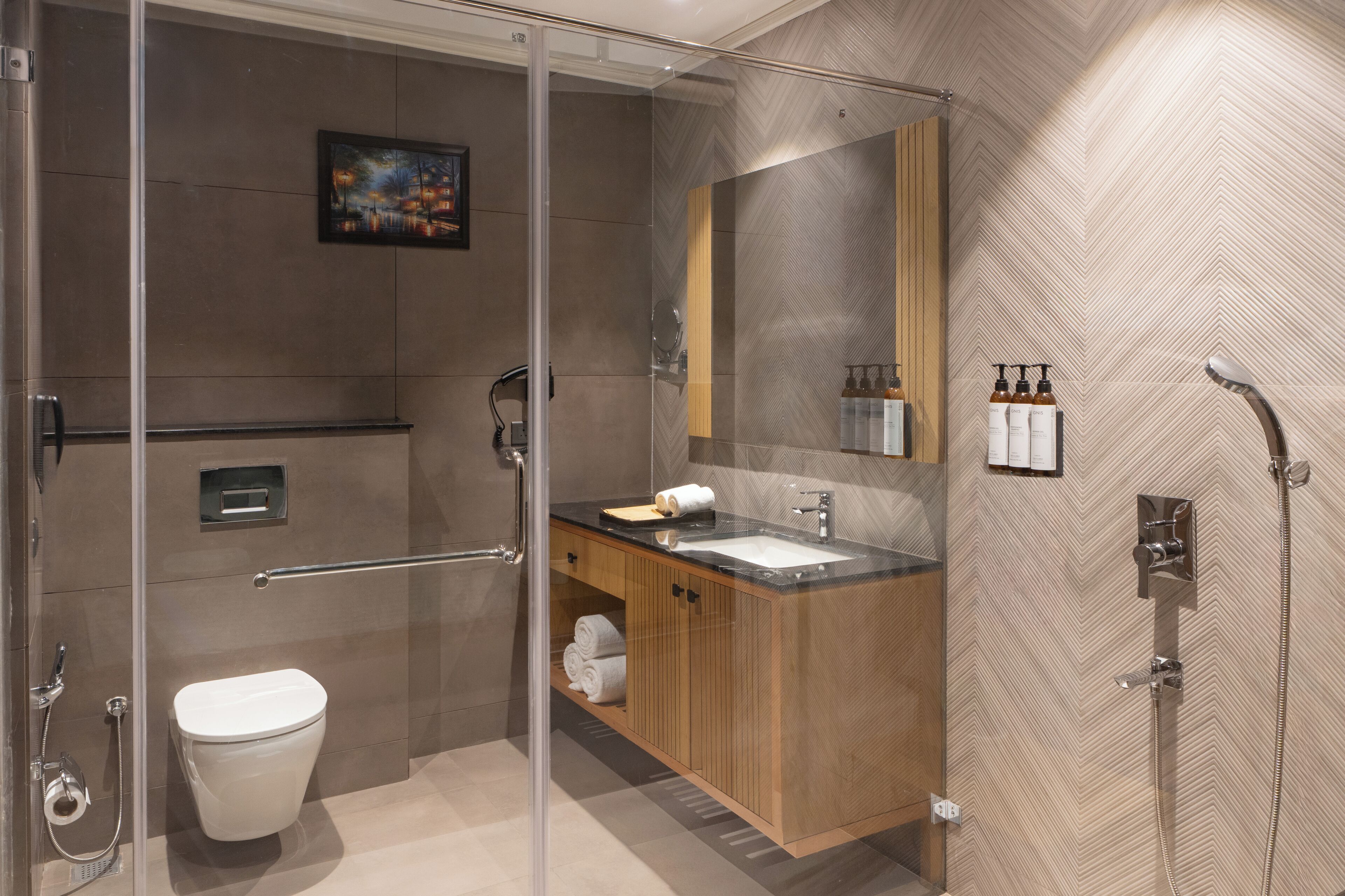 A modern bathroom with a glass-enclosed shower, a wooden vanity, a large mirror, and a toilet.