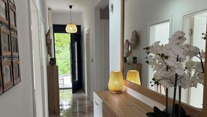 A modern bathroom with a large mirror, a sink, and a toilet. - The house is our passion project, built with love surrounded by forest and views (Kamenari)