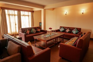 A living room with two sofas, a coffee table, and a bench.