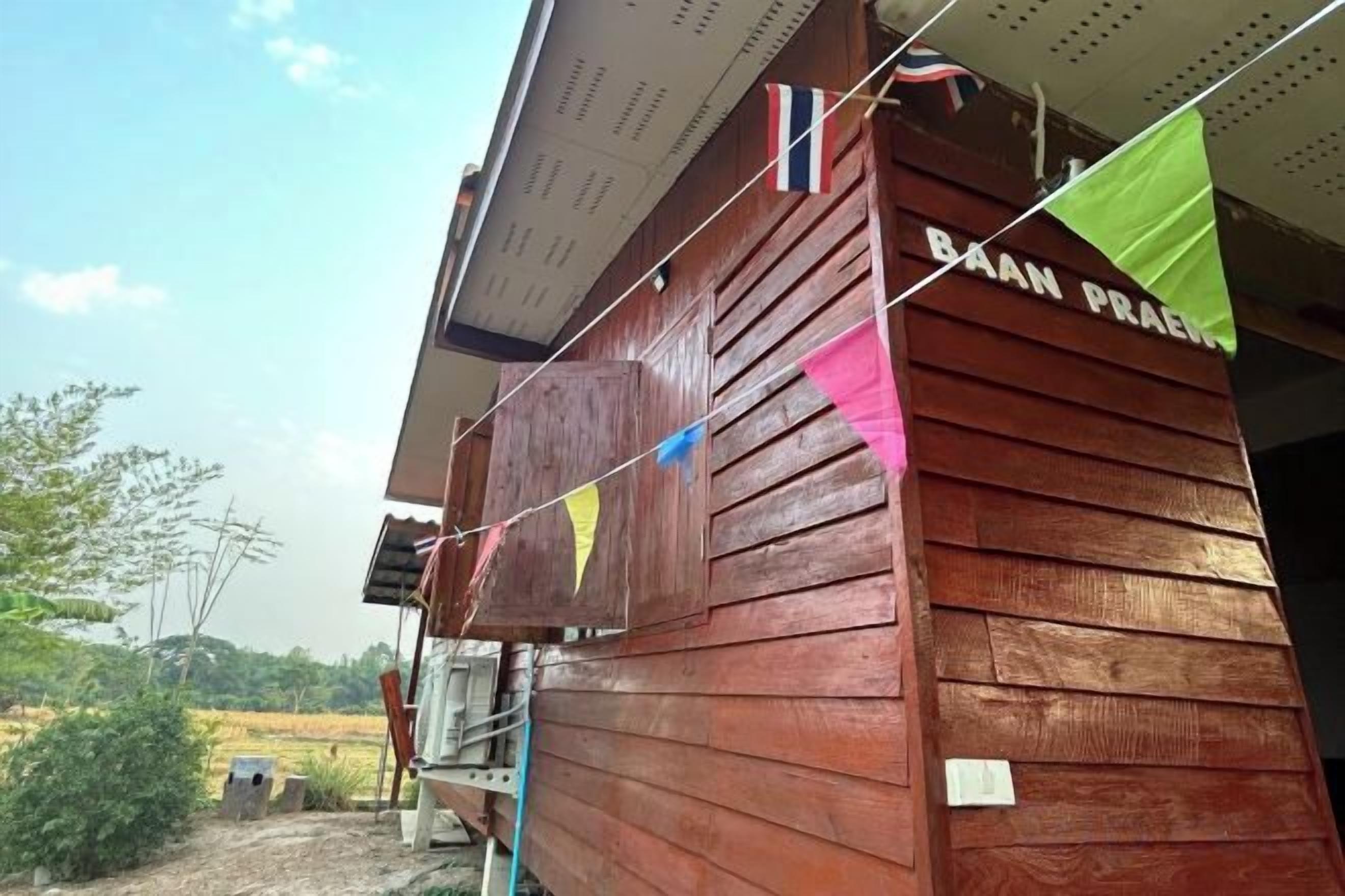 A wooden building with the name 'BAAN PRAEN' on the side.