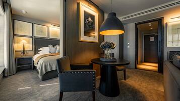 Signature Suite | In-room safe, desk, laptop workspace, iron/ironing board