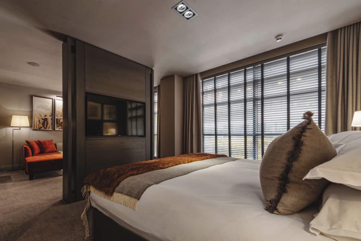 Signature Suite | In-room safe, desk, laptop workspace, iron/ironing board