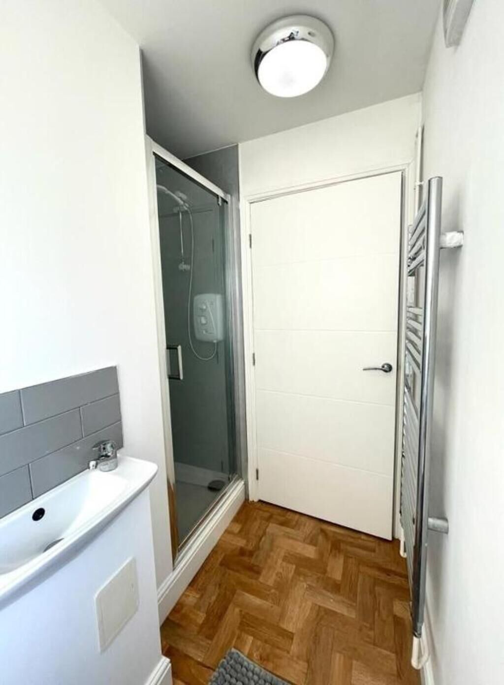 A bathroom with a shower, a toilet, and a sink.