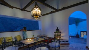 A dining area with a table, chairs, and a hanging light fixture. - Andalusian Villa with moorish touch and "Hammam" pool (Granada/Albuñol/La Rábita)