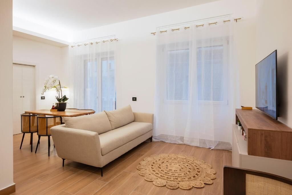 A modern living room with a sofa, a coffee table, and a TV.