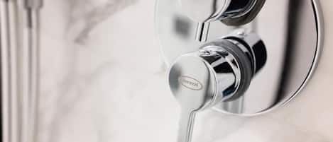 A modern bathroom with a chrome faucet and a visible brand name.