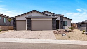 A modern two-story house with a garage, a driveway, and a landscaped front yard. - Game Room • New Construction • 5 Bedrooms, 2 Baths (Mesquite)