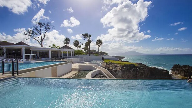 A pool area with a view of the ocean and a covered seating area. - Bubble Glamping, Family 2 Beds, we Have a 12 Units Like This! (Sosúa)