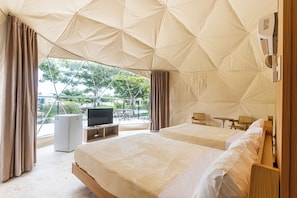 A tented accommodation with two beds, a television, and a small table. - Bubble Glamping, Family 2 Beds, we Have a 12 Units Like This! (Sosúa)