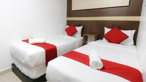A hotel room with two beds, each with white bedding and red accents, a wooden headboard, and a large mirror above the beds. - Red Velvet Inn Bukit Bintang (Kuala Lumpur)