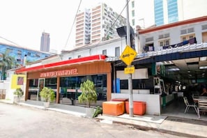 A hotel with a red awning, a visible entrance, and a signboard. - Red Velvet Inn Bukit Bintang (Kuala Lumpur)