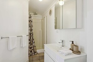 Shower, hair dryer, towels, shampoo