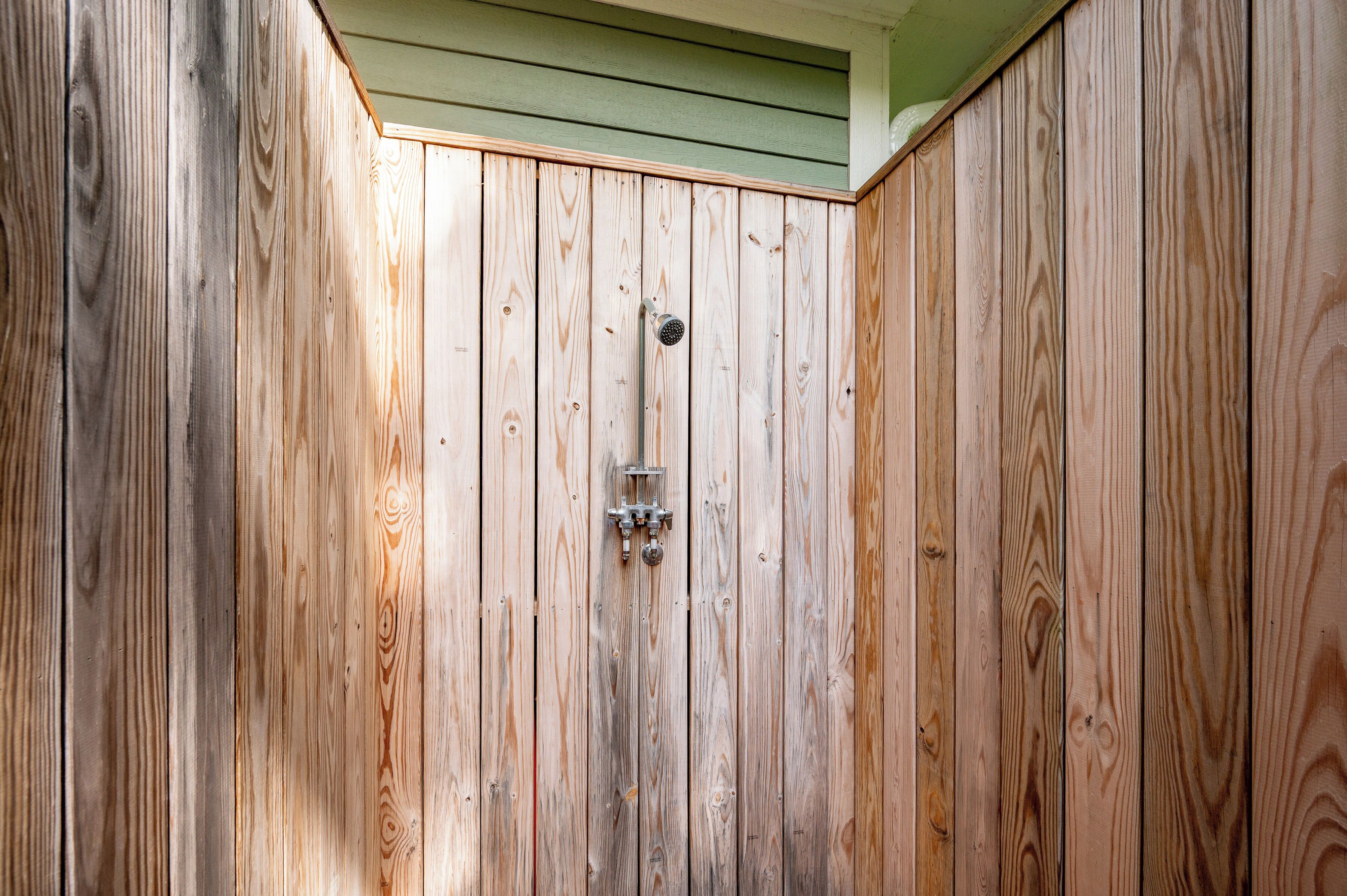 A wooden gate with a metal latch and a small window.