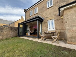 A stone house with a glass door entrance leading to a cozy interior. - West Lodge, 5 Bedroom House, Dog Friendly, EV Charger + Great Location. (Buxton)